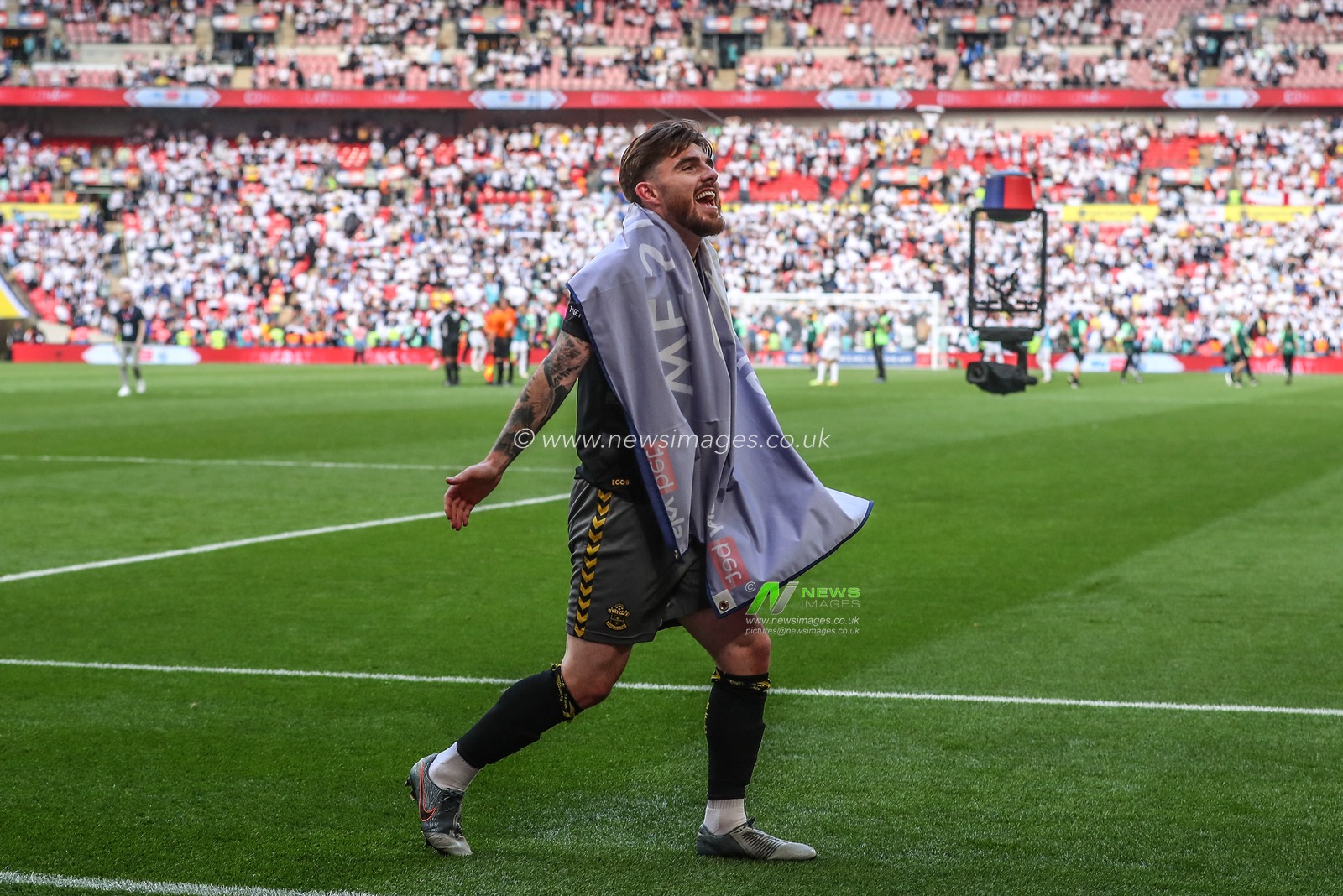 Ryan Manning of Southampton celebrates his team winning promotion to the Premier League during the Sky Bet Championship Play-Off Final match Leeds United vs Southampton at Wembley Stadium, London, United Kingdom, 26th May 2024

(Photo by Gareth Evans/News Images)
