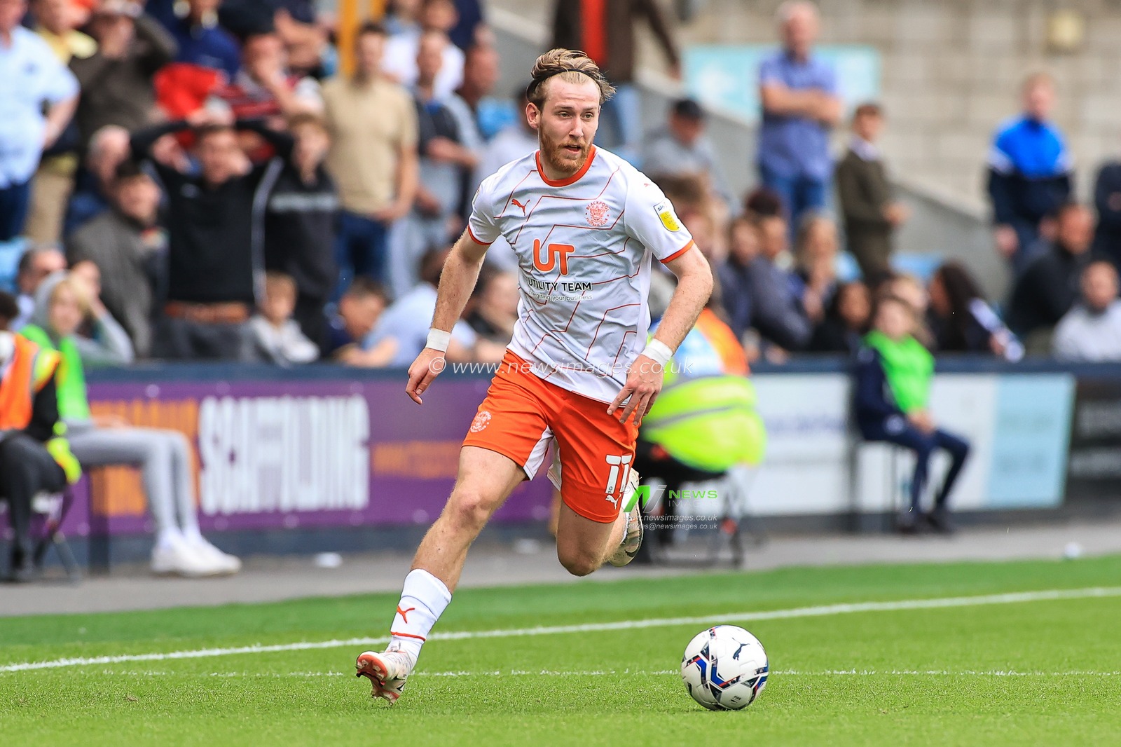 Josh Bowler #11 of Blackpool makes a break with the ball