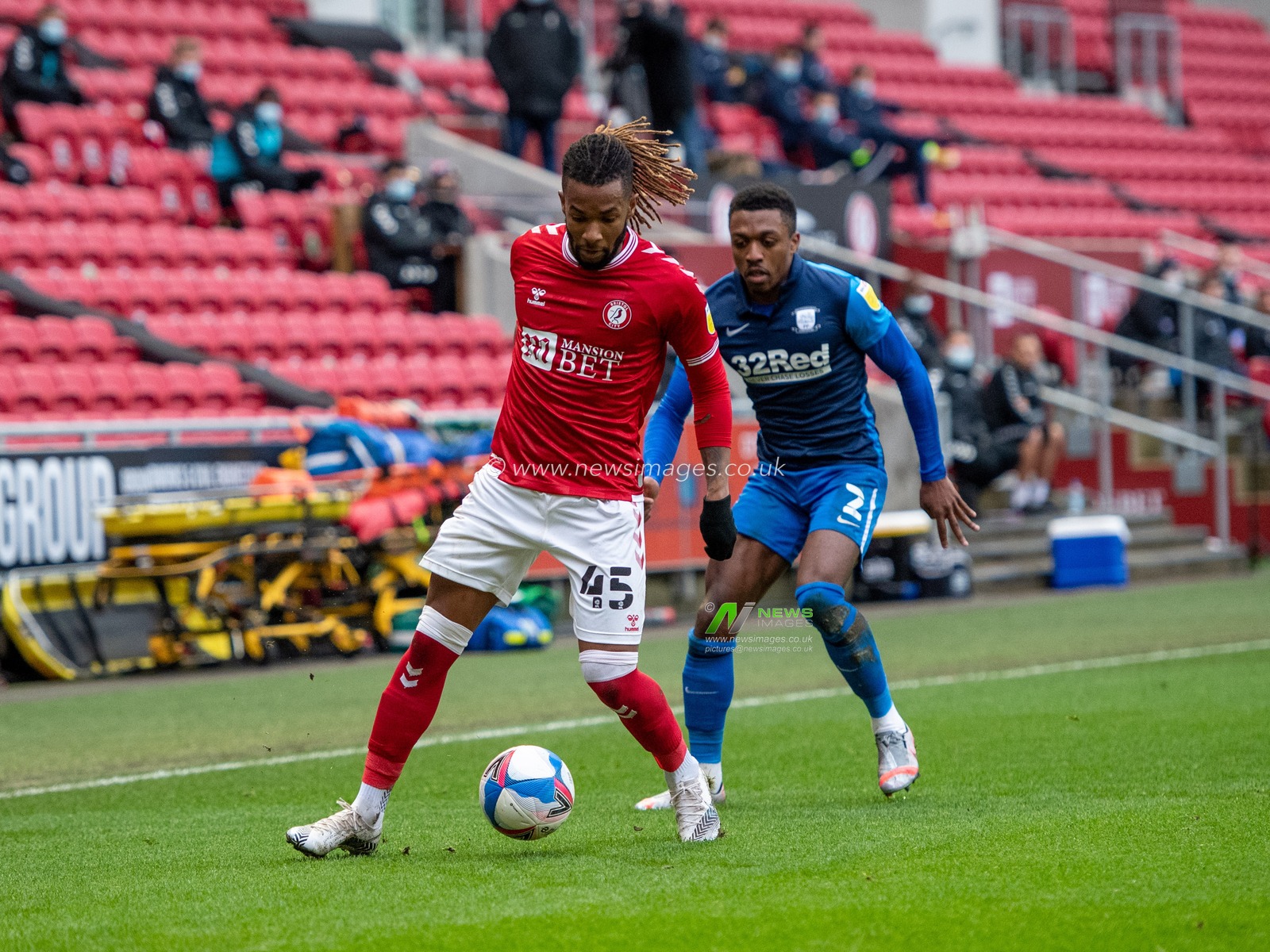 Kasey Palmer #45 of Bristol City holds the ball under pressure from Darnell Fisher #2 of Preston North End