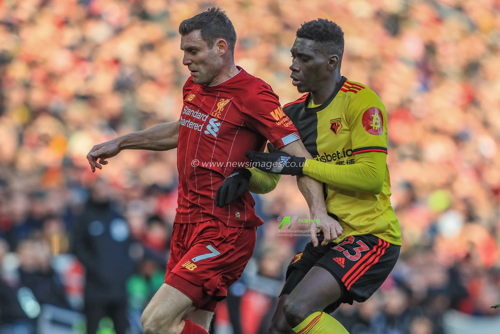 14th December 2019, Anfield, Liverpool, England; Premier League, Liverpool v Watford :  Ismaila Sarr (23) of Watford holds off James Milner (7) of Liverpool 

Credit: Mark Cosgrove/News Images