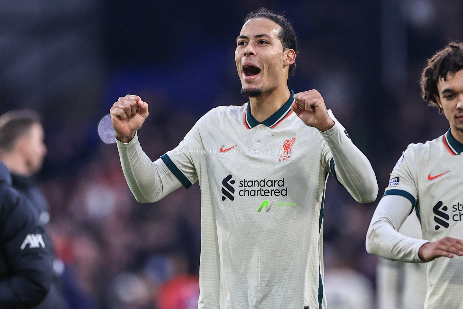 Virgil van Dijk #4 of Liverpool celebrates with the traveling fans