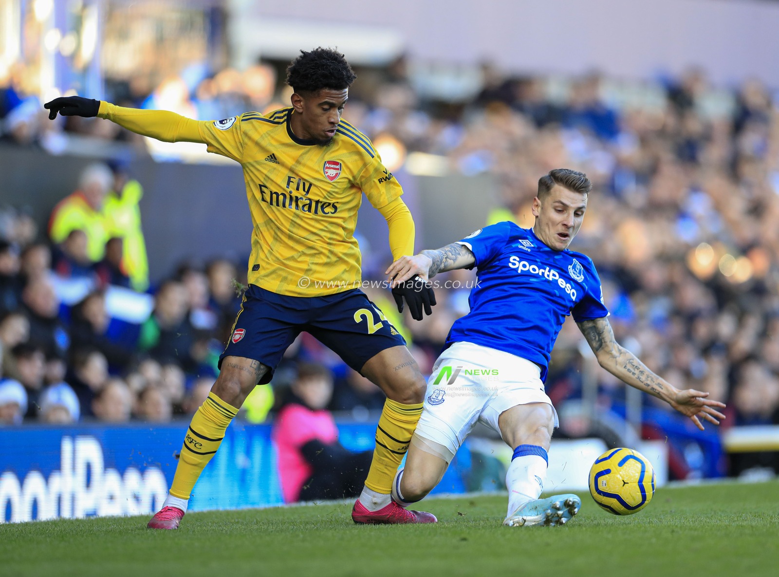 21st December 2019, Goodison Park, Liverpool, England; Premier League, Everton v Arsenal : Reiss Nelson (24) of Arsenal and Lucas Digne (12) of Everton challenge for the ball
Credit: Conor Molloy/News Images