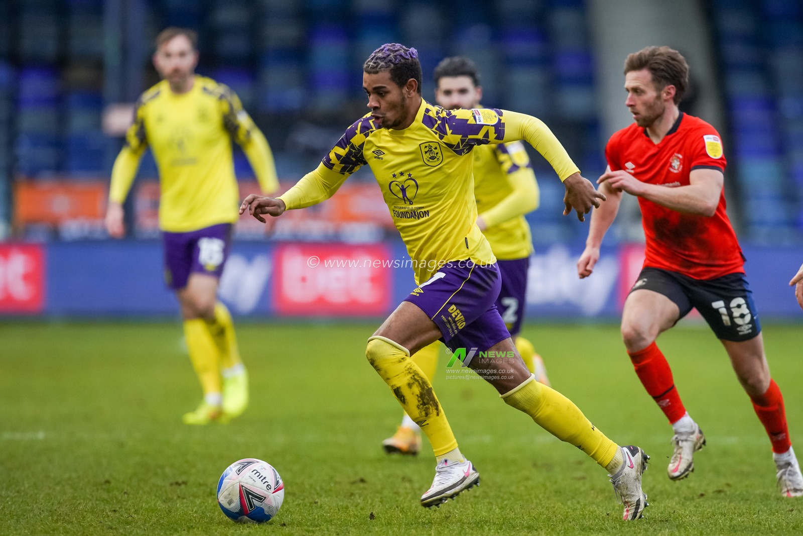 Juninho Bacuna #7 of Huddersfield Town in action