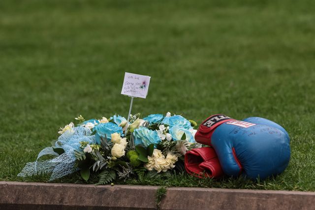 A boxing glove and flowers are laid outside the entrance to the cathedral during Ricky Hatton' Funeral at Manchester Cathedral, Manchester, United Kingdom, 10th October 2025

(Photo by Mark Cosgrove/News Images)