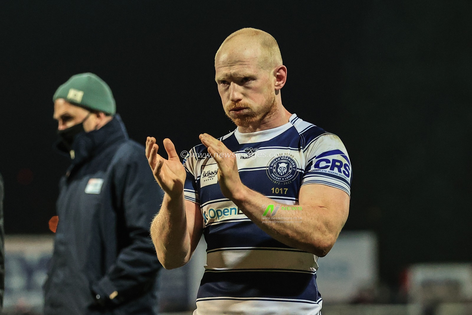 Liam Farrell #12 of Wigan Warriors applauds the traveling fans as Wigan win Hull KR 10-24