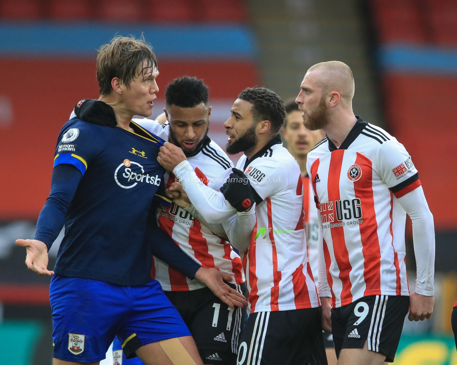 Temper flair between Oliver McBurnie #9 of Sheffield United and Jannik Vestergaard #4 of Southampton