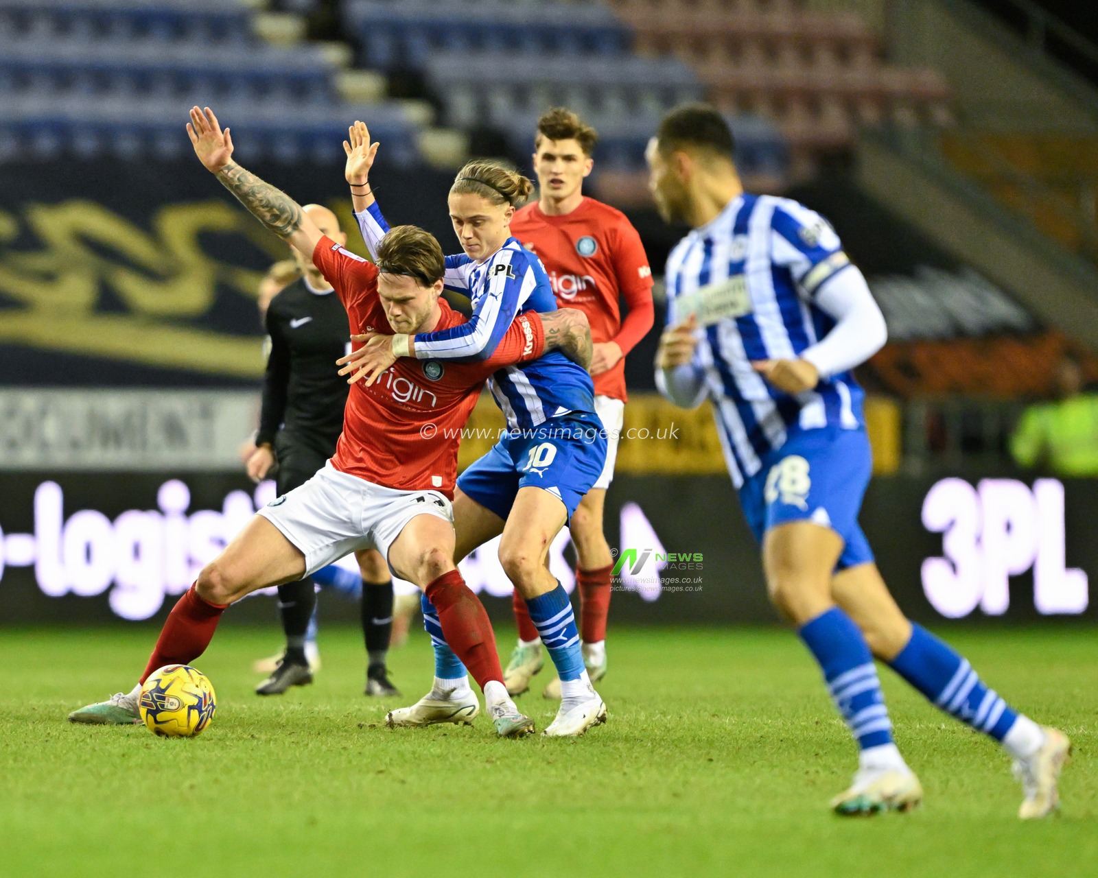 Kieran Sadlier of Wycombe Wanderers holds the ball up while under pressure from Thelo Aasgaard of Wigan Athletic, during the Sky Bet League 1 match Wigan Athletic vs Wycombe Wanderers at DW Stadium, Wigan, United Kingdom, 23rd January 2024

(Photo by Cody Froggatt/News Images)