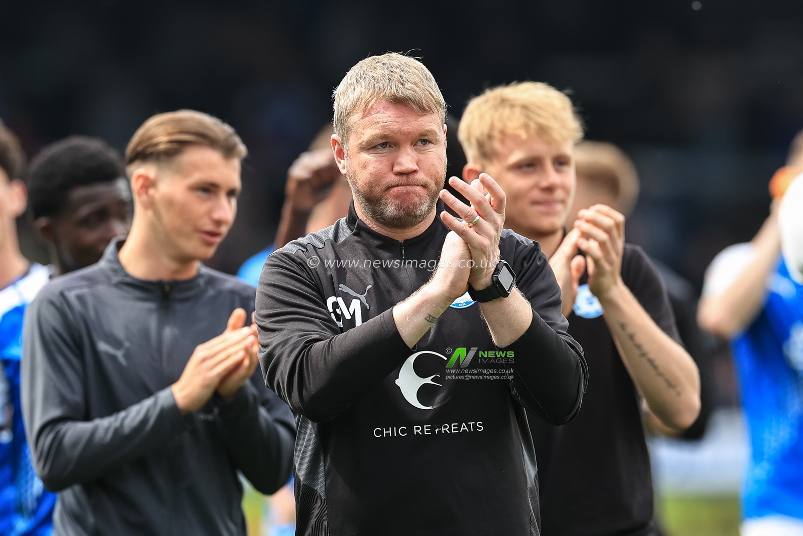 Grant McCann manager of Peterborough United applauds the traveling Blackpool fans