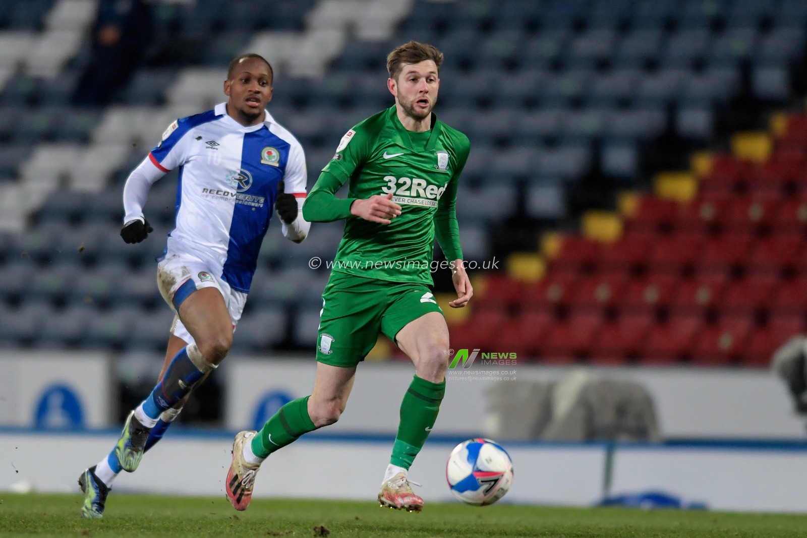 Tom Barkhuizen #29 of Preston North End breaks forward with the ball while being chased by Ryan Nyambe #2 of Blackburn Rovers