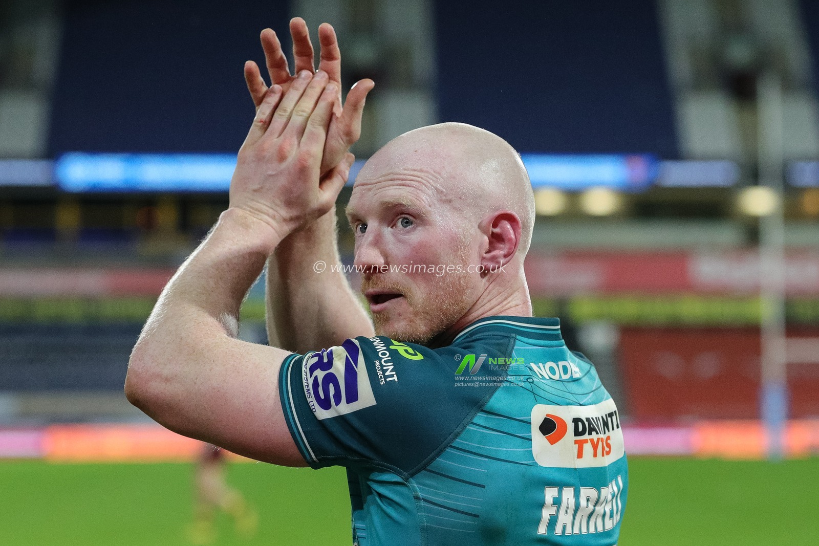 Liam Farrell #12 of Wigan Warriors claps his hands and applauds the supporters at full-time after the Betfred Super League Round 5 match Huddersfield Giants vs Wigan Warriors at John Smith's Stadium, Huddersfield, United Kingdom, 17th March 2023

(Photo by James Heaton/News Images)