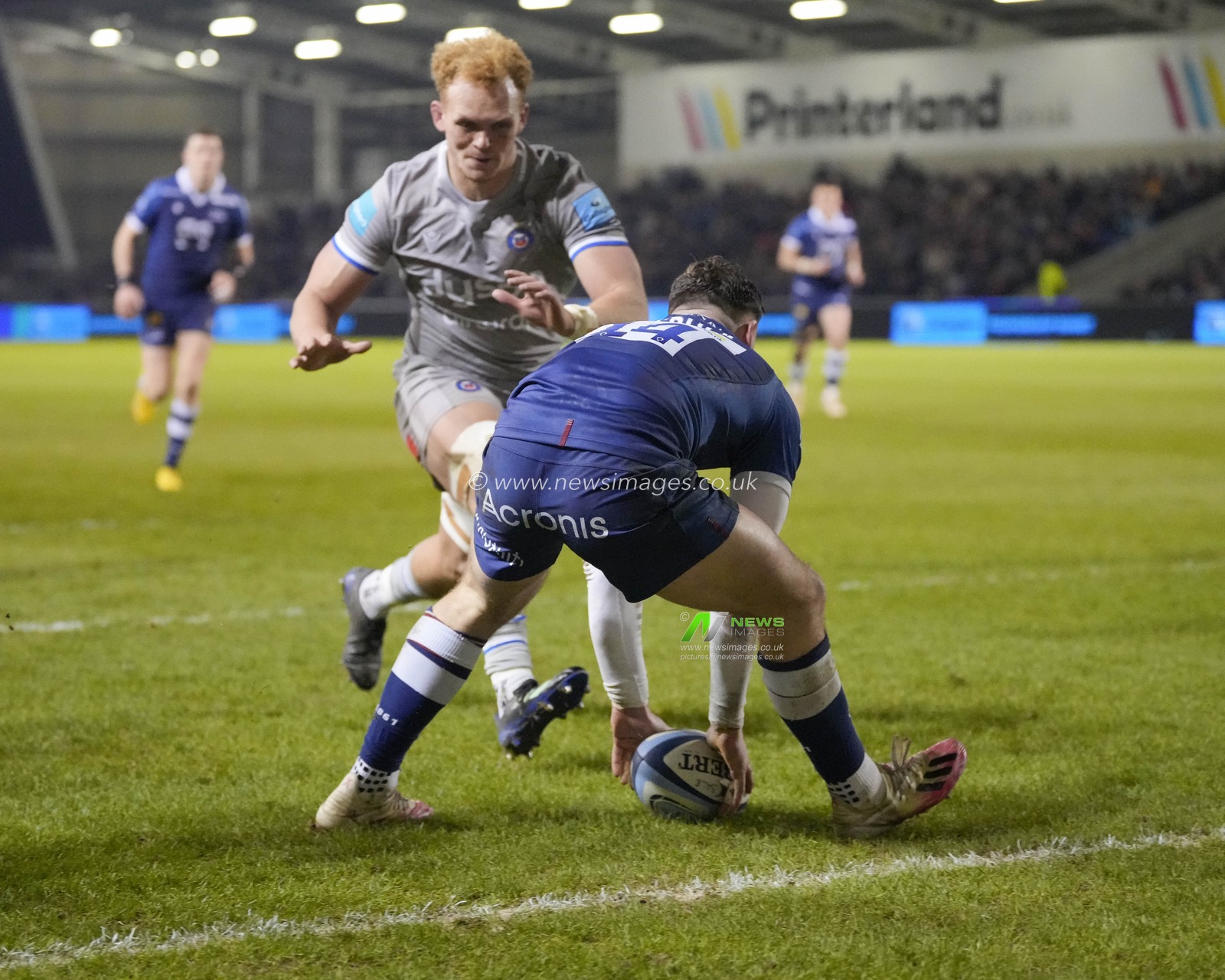 Tom Roebuck #14 of Sale Sharks runs in to score a try under pressure from Miles Reid #8 of Bath Rugby  during the Gallagher Premiership match Sale Sharks vs Bath Rugby at AJ Bell Stadium, Eccles, United Kingdom, 27th January 2023

(Photo by Steve Flynn/News Images)