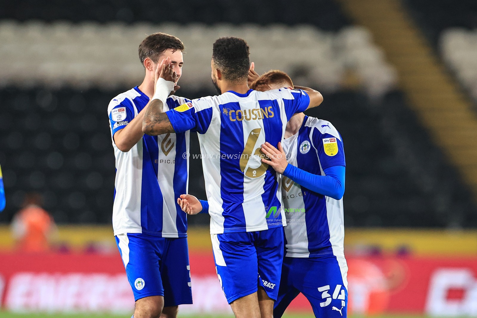 Jordan Cousins #6 of Wigan Athletic celebrates scoring the winning penalty with team mates