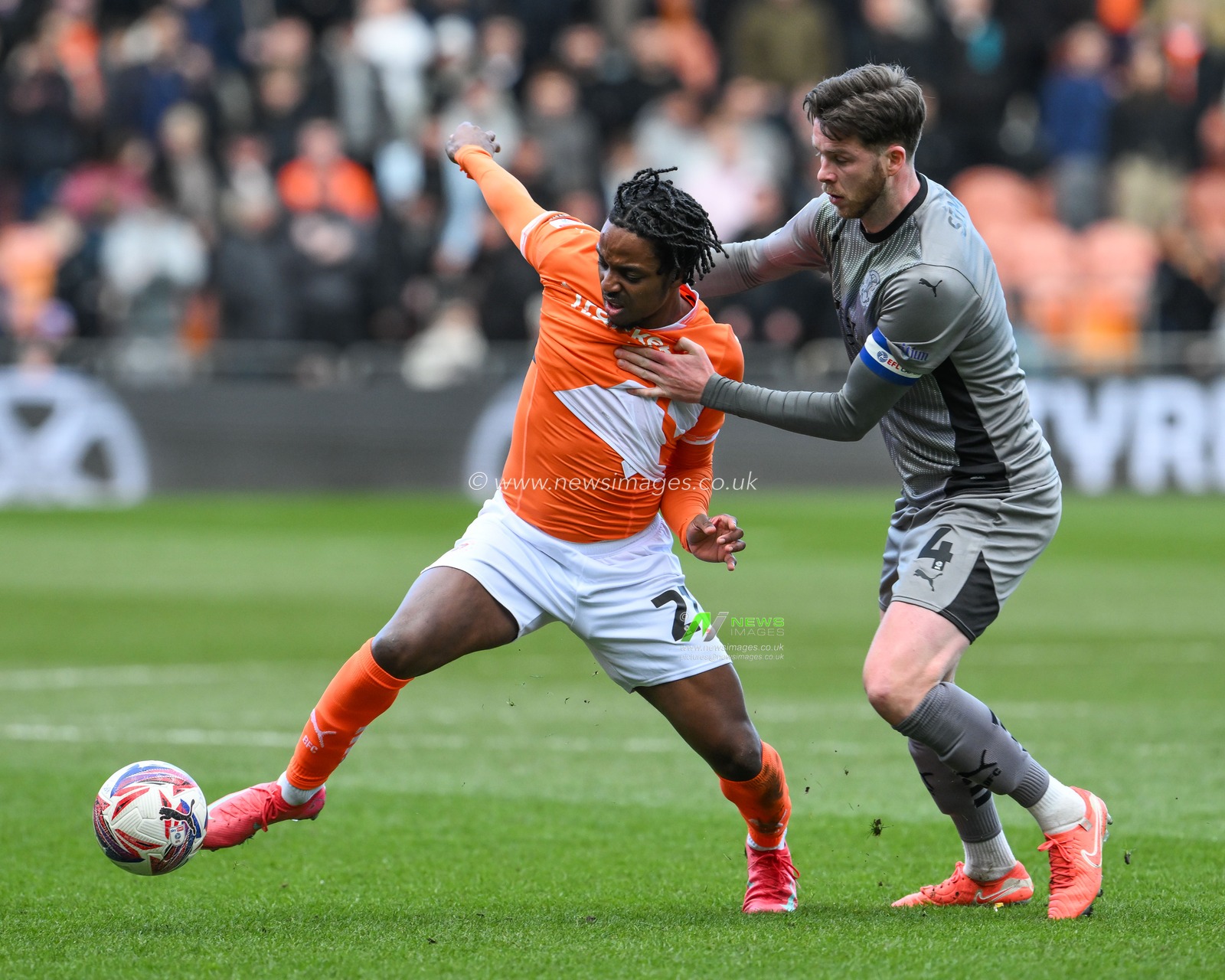 Niall Ennis of Blackpool is held back by Jack Simpson of Leyton Orient during the Sky Bet League 1 match Blackpool vs Leyton Orient at Bloomfield Road, Blackpool, United Kingdom, 15th March 2025

(Photo by Craig Thomas/News Images)