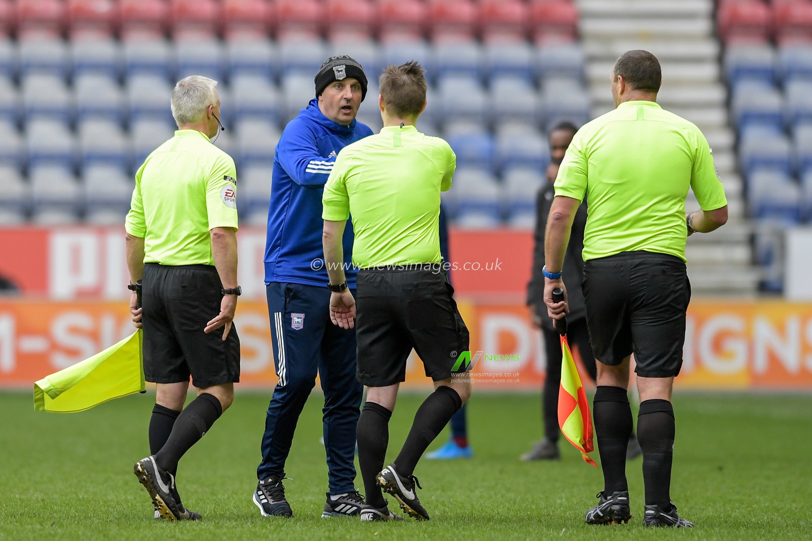 Paul Cook manager of Ipswich Town speaks to referee James Bell at the end of the game