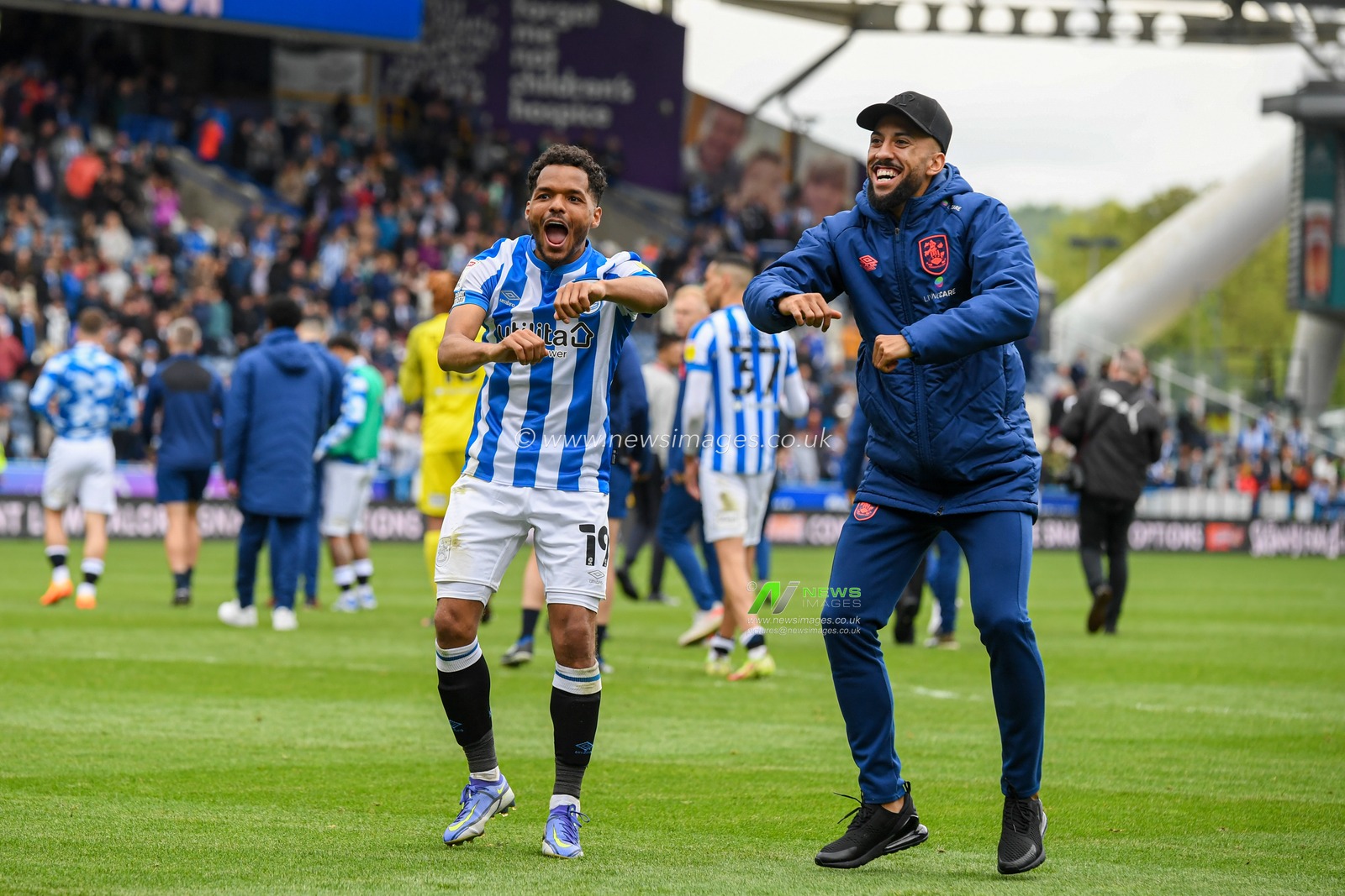 Duane Holmes #19 and Sorba Thomas #16 of Huddersfield Town celebrate beating Bristol City 2-0 in front of the home supporters