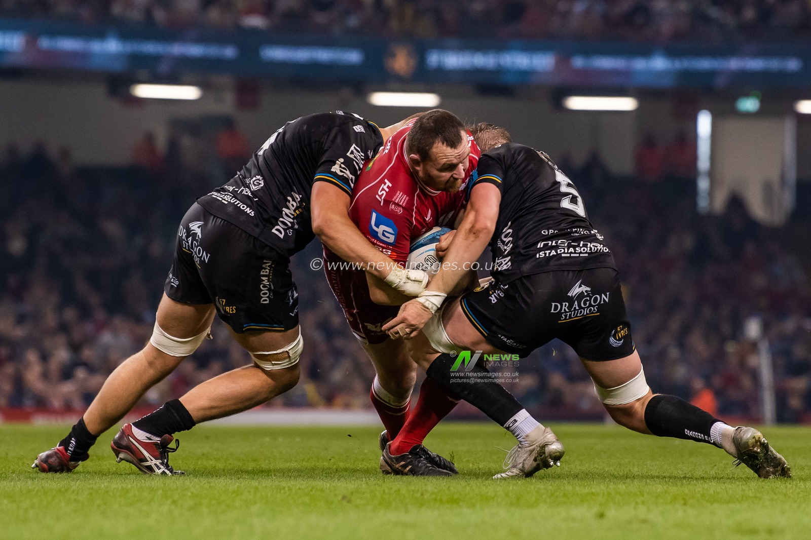 Ken Owens of Scarlets is tackled by Matthew Screech and George Nott of the Dragons during the United Rugby Championship match Dragons Rugby vs Llanelli Scarlets at Principality Stadium, Cardiff, United Kingdom, 22nd April 2023

(Photo by Craig Thomas/News Images)