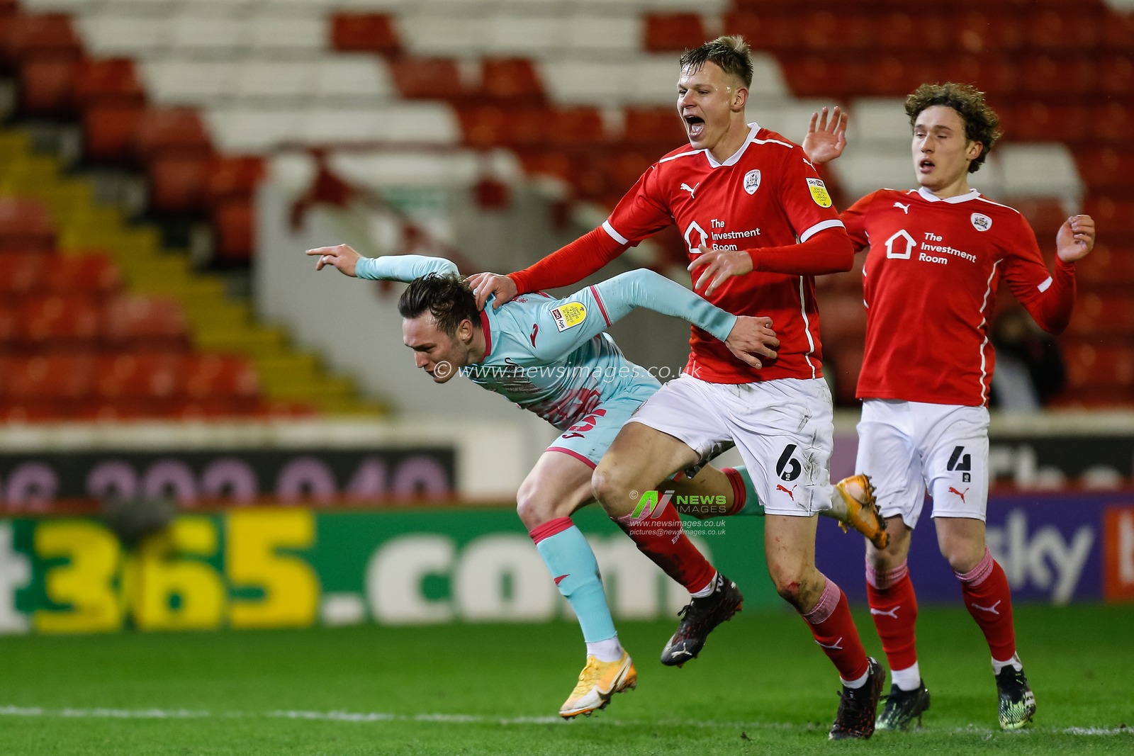 Mads Juel Andersen #6 of Barnsley brings down Connor Roberts #23 of Swansea City