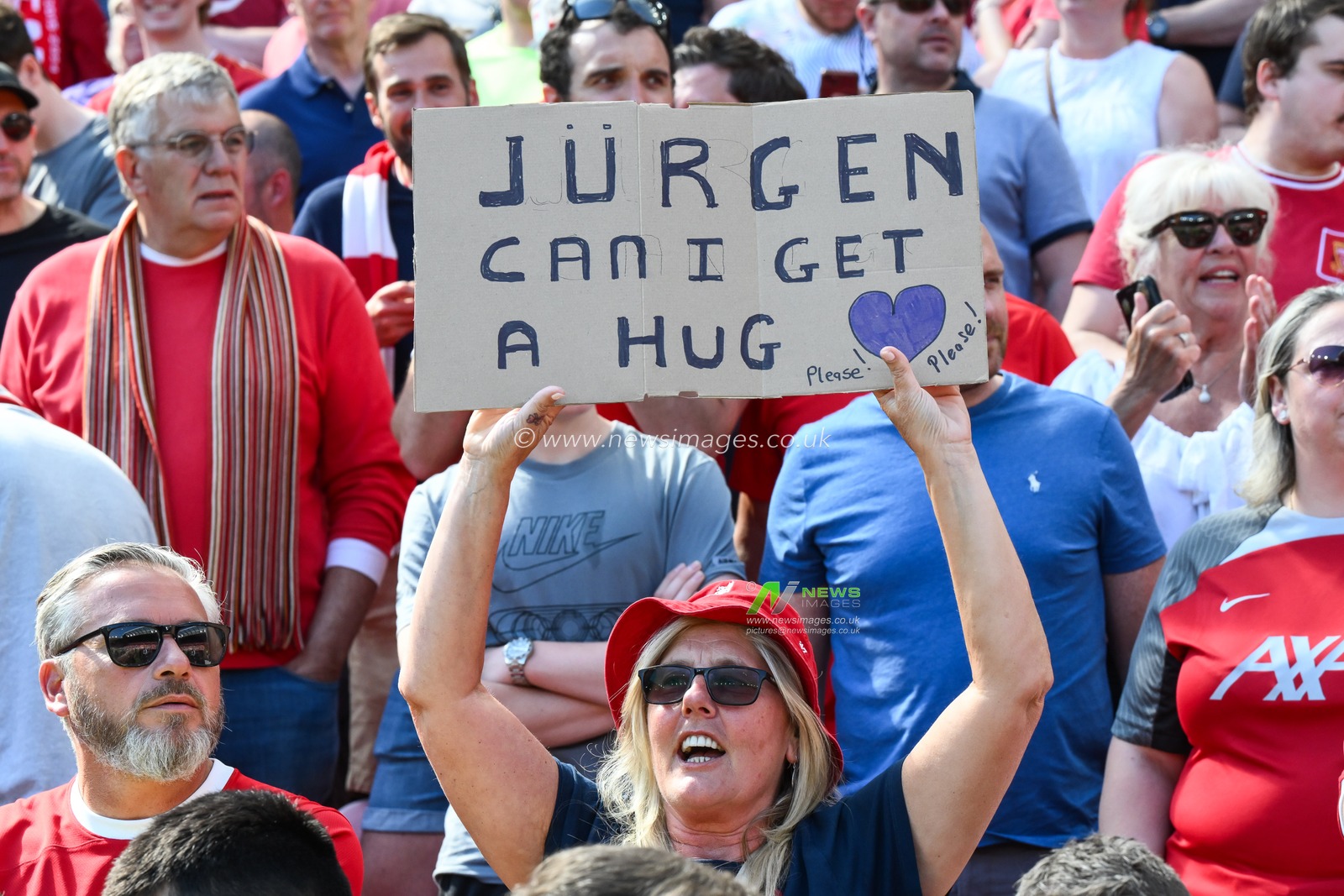 A fan holds up a sign for a hug during the Premier League match Liverpool vs Wolverhampton Wanderers at Anfield, Liverpool, United Kingdom, 19th May 2024

(Photo by Craig Thomas/News Images)