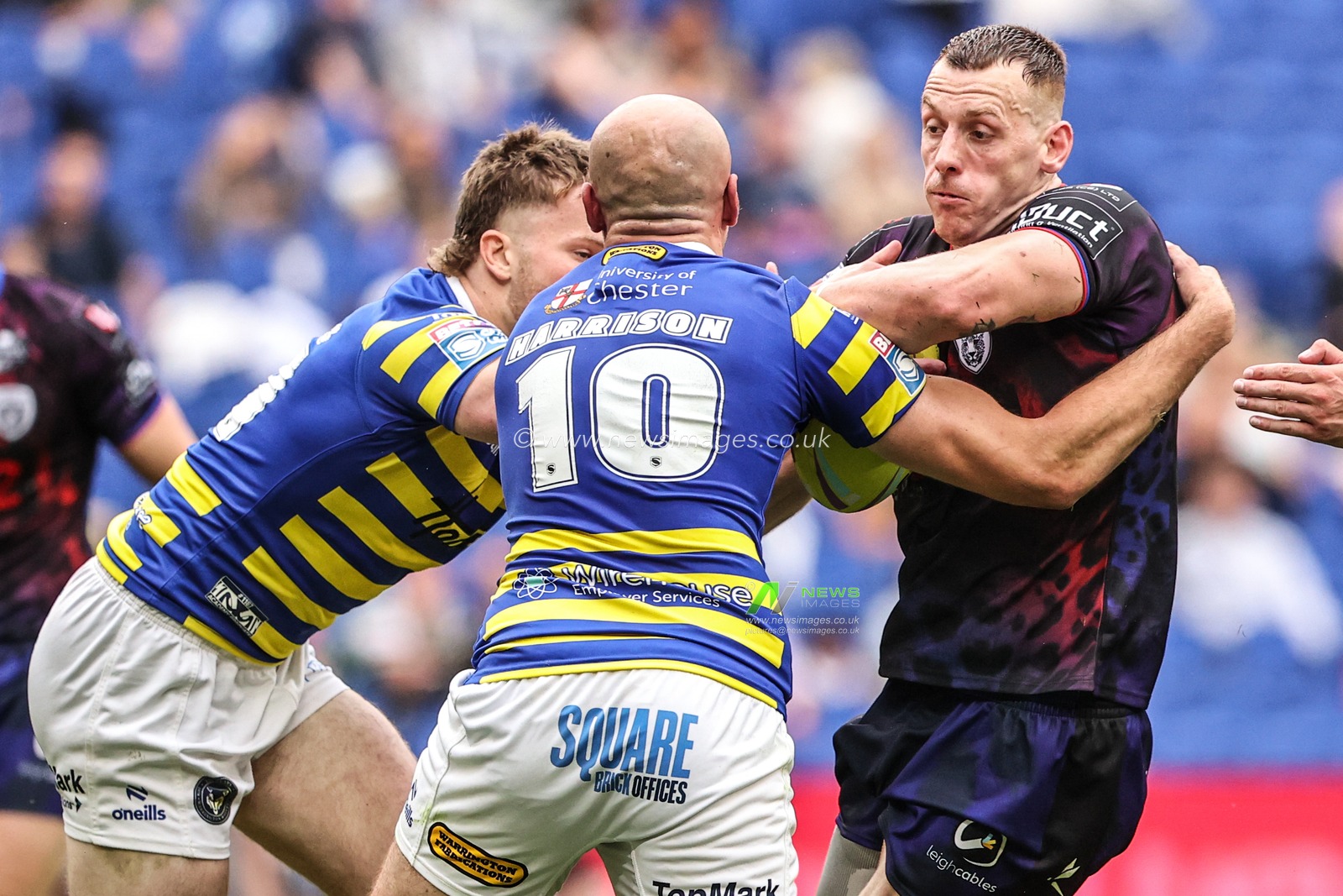 Frankie Halton of Leigh Leopards is tackled by James Harrison of Warrington Wolves and Luke Thomas of Warrington Wolves during the Betfred Super League Magic Weekend match Leigh Leopards vs Warrington Wolves at Leigh Sports Village, Leigh, United Kingdom on 04 July 2026

(Photo by Alfie Cosgrove/News Images)