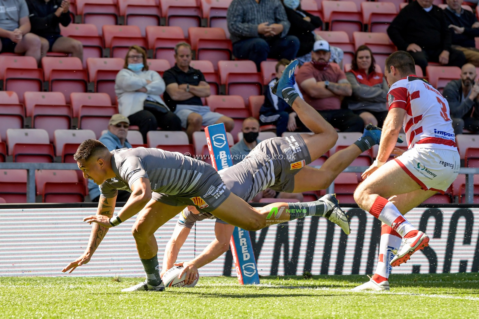 Tom Davies (2) of Catalans Dragons goes over for a try