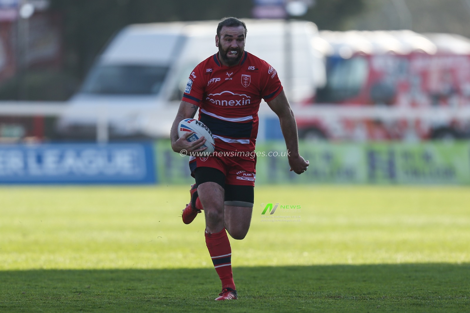 Kane Linnett #12 of Hull KR runs with the ball