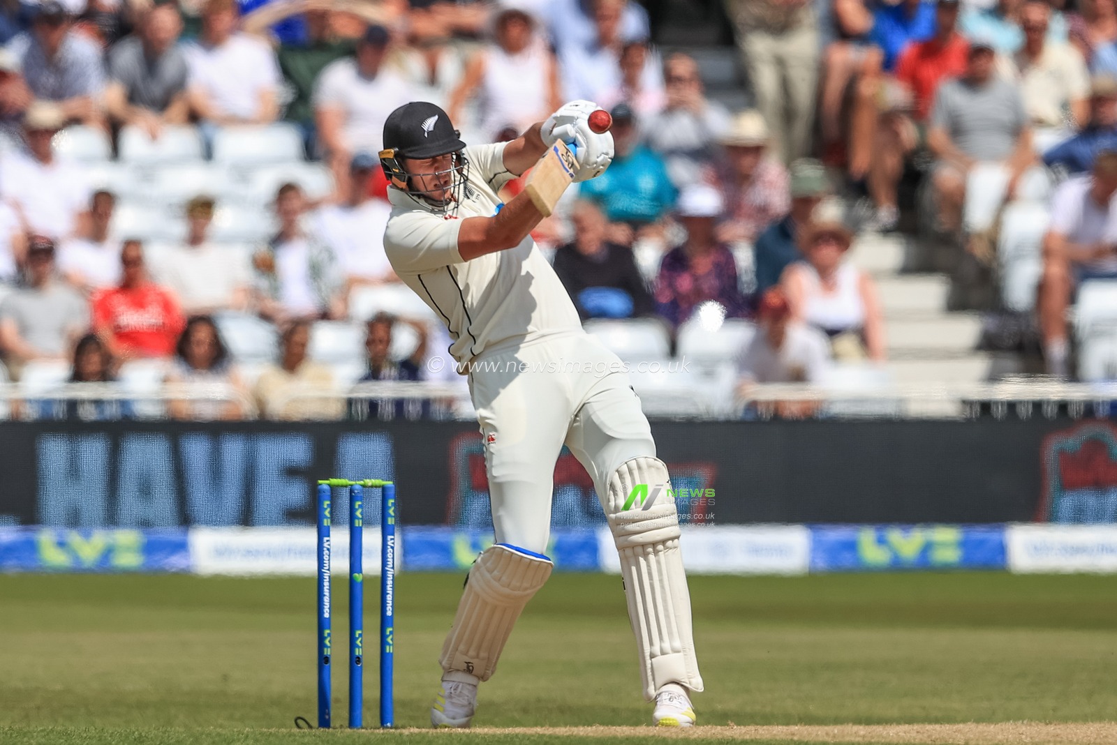 Kyle Jamieson of New Zealand swings at the ball before being caught behind by Ben Foakes of England
