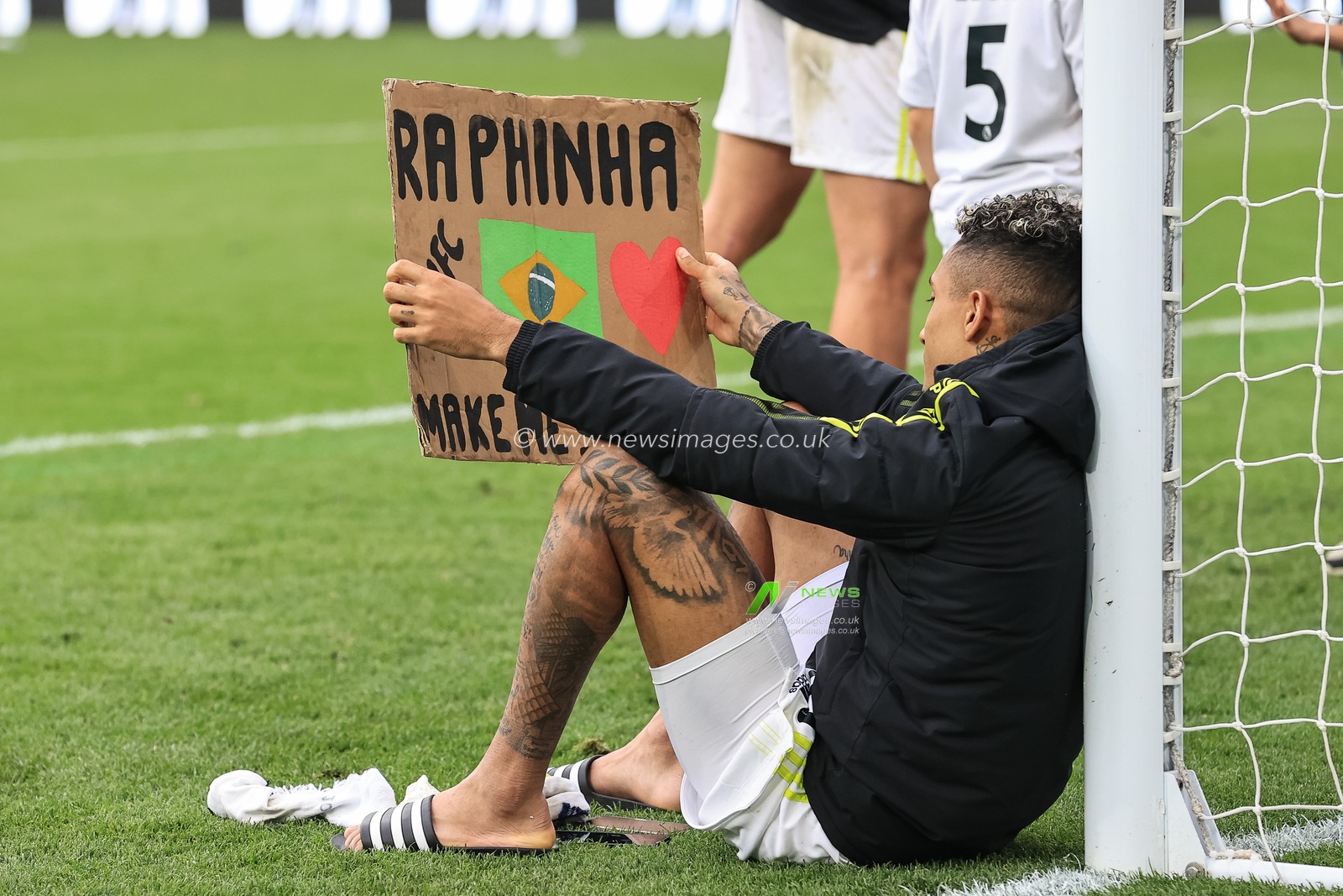 Raphinha #10 of Leeds United with the home made Raphinha banner