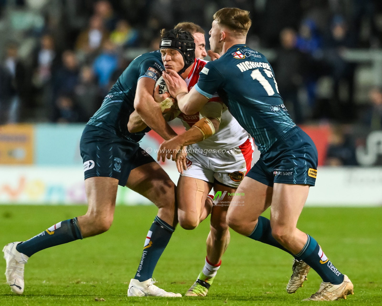 Jonny Lomax #6 of St Helens is tackled by Matty Nicholson #12 and James Harrison #8 of Warrington Wolves during the Betfred Super League match St Helens vs Warrington Wolves at Totally Wicked Stadium, St Helens, United Kingdom, 20th April 2023

(Photo by Craig Thomas/News Images)