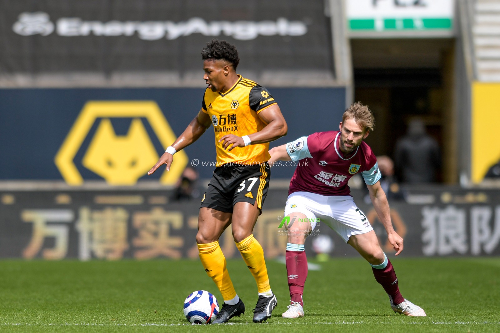 Adama Traore #37 of Wolverhampton Wanderers and Charlie Taylor #3 of Burnley compete for the ball