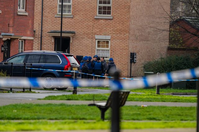 Officers with ordinance unit vests and a dog about to enter an address on Vulcan Street, during a Major Explosives Incident in Derby that began on Thursday December 4 when police executed a warrant at an address on Vulcan Street, Derby, that saw two men arrested on suspicion of explosives offences and 200 homes evacuated (Maynard Manyowa / News Images)