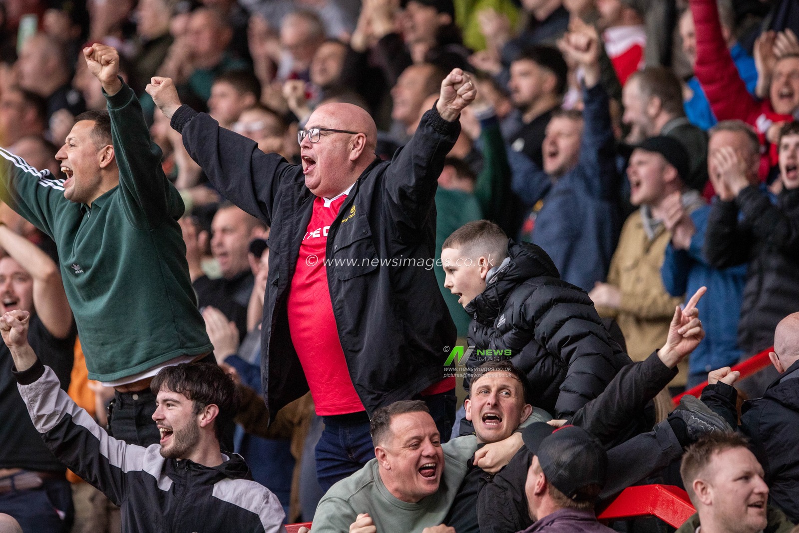 Wrexham fans celebrate their victory following the Sky Bet League 1 match Wrexham vs Stockport County at SToK Cae Ras, Wrexham, United Kingdom, 22nd March 2025

(Photo by Nik Mesney/News Images)