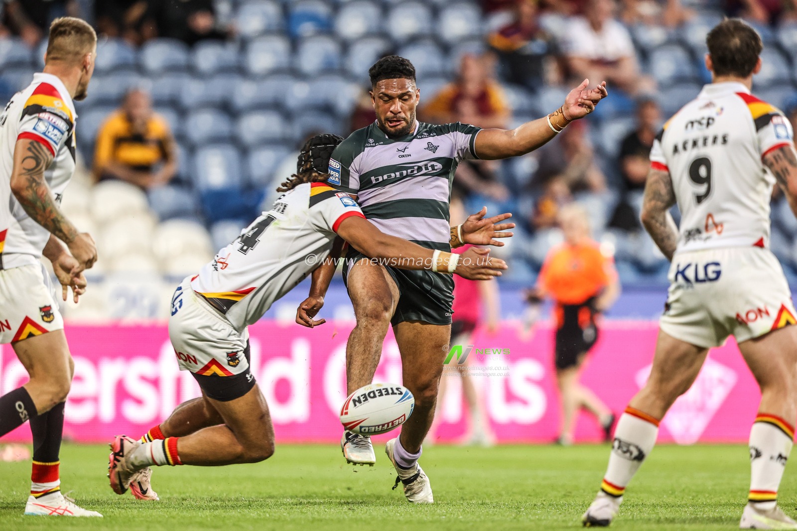 Taane Milne of Huddersfield Giants kicks the ball away as he is tackled by Guy Armitage of Bradford Bulls during the Betfred Super League round 18 match Huddersfield Giants vs Bradford Bulls at Accu Stadium, Huddersfield, United Kingdom on 10 July 2026

(Photo by Alfie Cosgrove/News Images)
