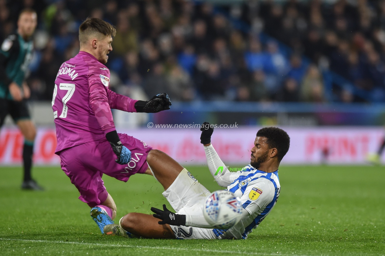 26th November 2019, John Smith's Stadium, Huddersfield, England; Sky Bet Championship, Huddersfield Town v Swansea City : Fraizer Campbell (22) of Huddersfield Town lunges onto a loose back pass and clashes with Freddie Woodman (27) of Swansea City.

Credit: Dean Williams/News Images