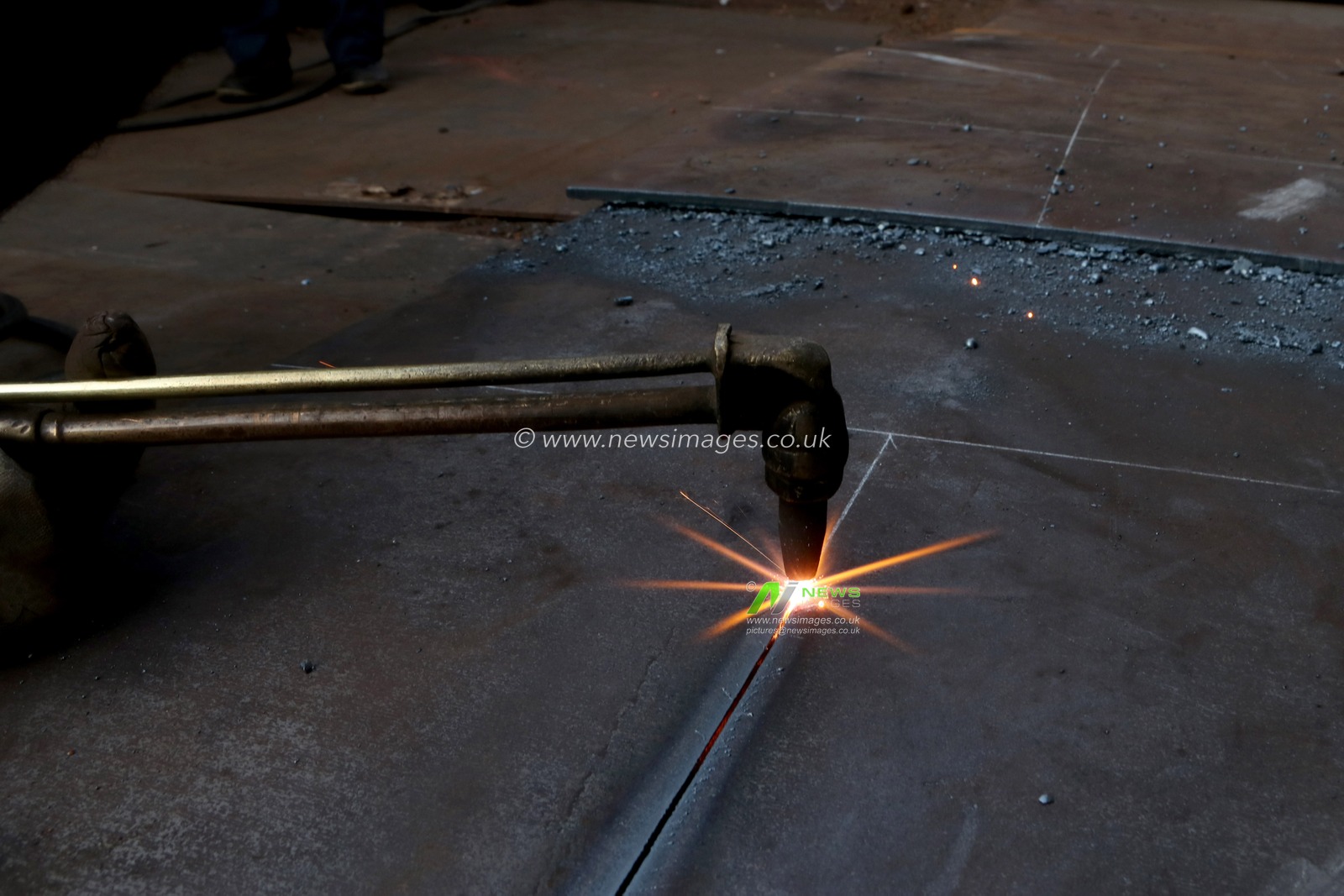 A labourer cuts an iron plate near a shop at a steel and iron wholesale market in Kolkata, India, Thursday, December 19,2024. Pictures by Debajyoti Chakraborty.(Photo: Debajyoti Chakraborty/News Images)