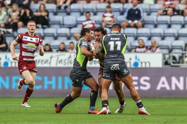 Patrick Mago of Wigan Warriors is tackled by Tariq Sims of Catalan Dragons during the Betfred Super League round 20 match Wigan Warriors vs Catalans Dragons at The Brick Community Stadium, Wigan, United Kingdom, 25th July 2025

(Photo by Alfie Cosgrove/News Images)