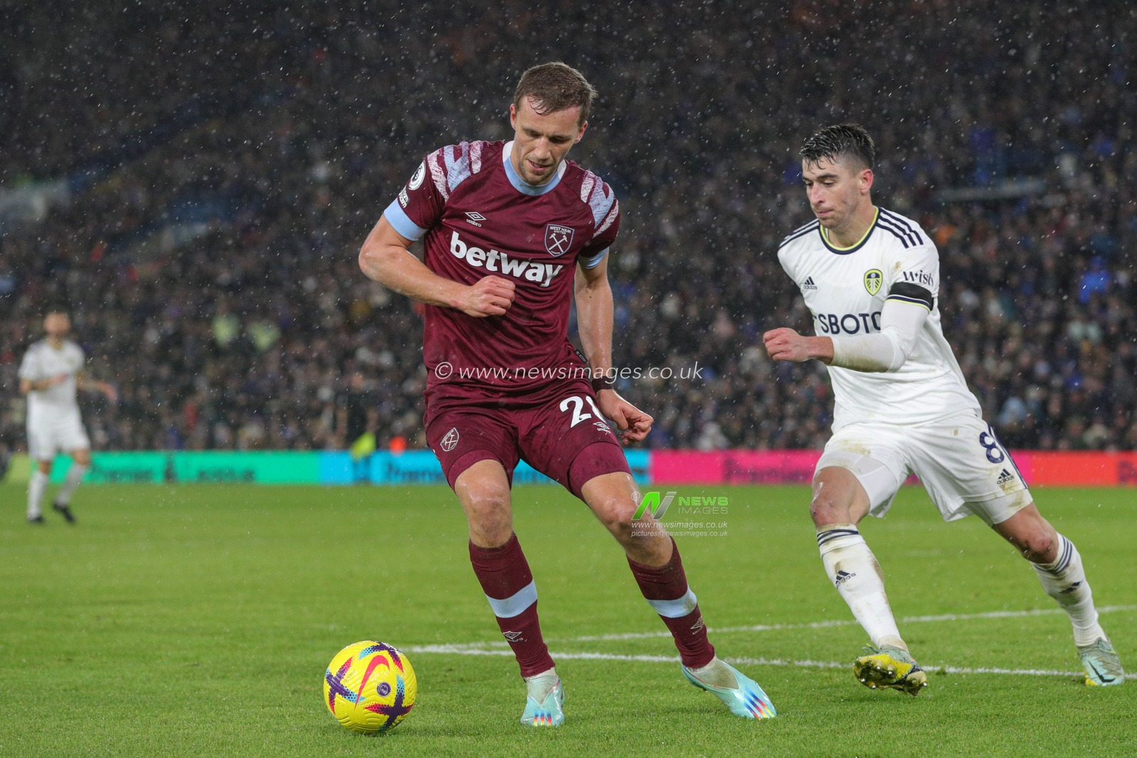 Jarrod Bowen #20 of West Ham United in action whilst being pressured by Marc Roca #8 of Leeds United during the Premier League match Leeds United vs West Ham United at Elland Road, Leeds, United Kingdom, 4th January 2023

(Photo by James Heaton/News Images)