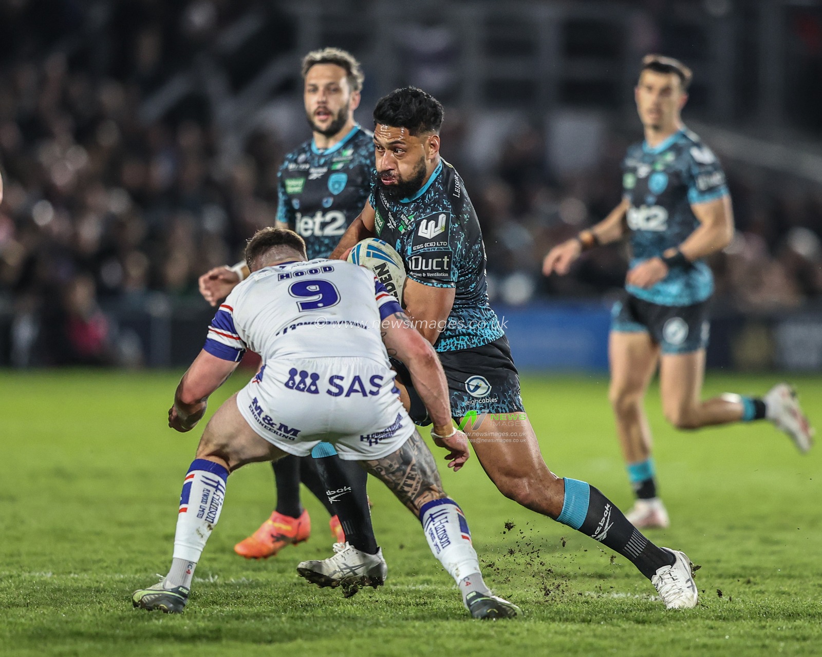 Isaac Liu of Leigh Leopards is tackled by Liam Hood of Wakefield Trinity during the Betfred Challenge Cup Quarter Final match Wakefield Trinity vs Leigh Leopards at DIY Kitchens Stadium, Wakefield, United Kingdom, 4th April 2025

(Photo by Alfie Cosgrove/News Images)