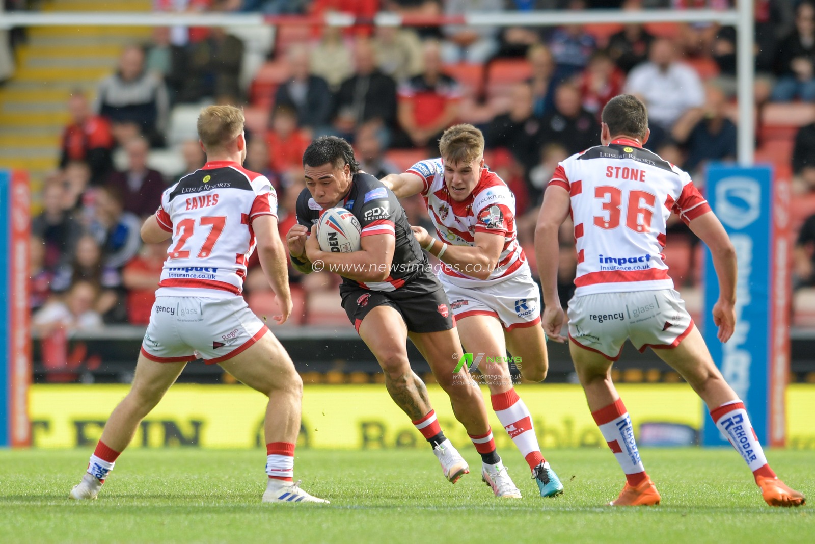 Ken Sio (2) of Salford Red Devils runs forward with the ball