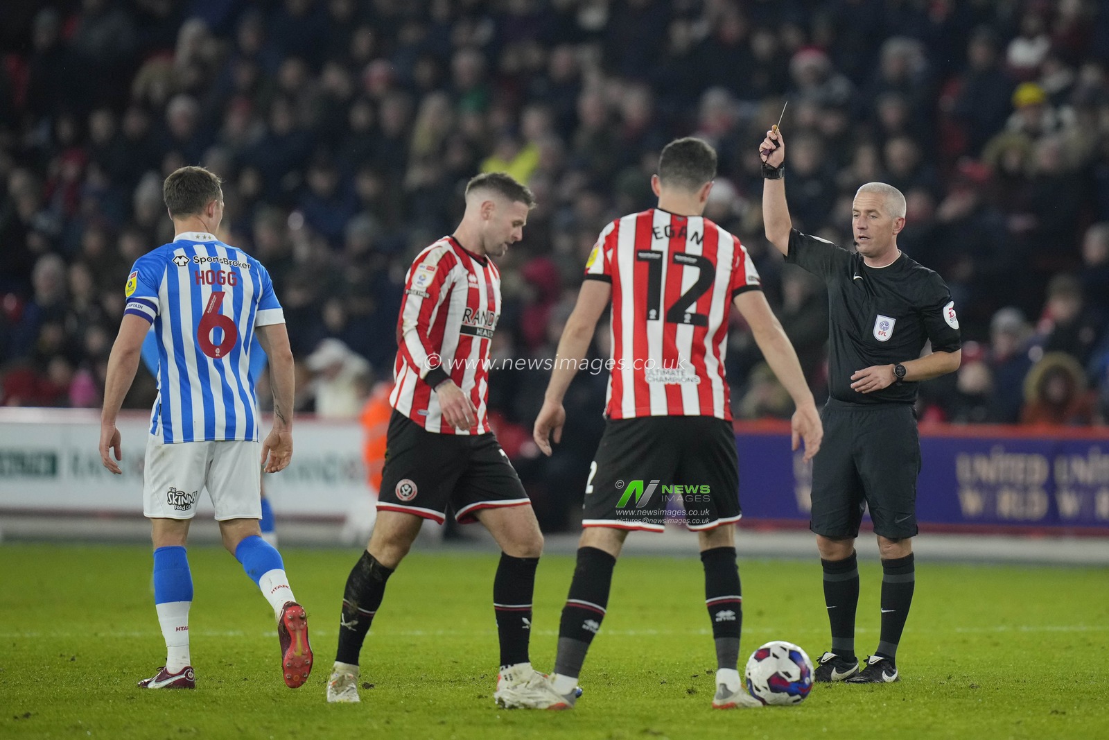 Referee Darren Bond shows a yellow card to Jonathan Hogg #6 of Huddersfield Town during the Sky Bet Championship match Sheffield United vs Huddersfield Town at Bramall Lane, Sheffield, United Kingdom, 10th December 2022

(Photo by Steve Flynn/News Images)