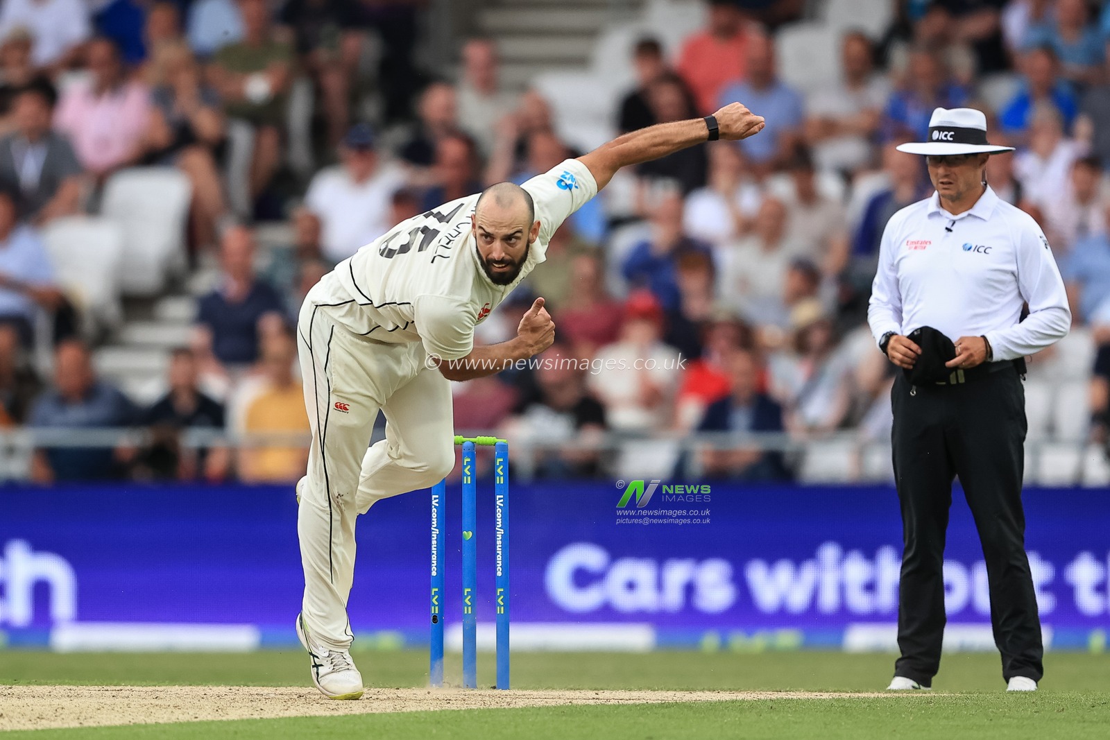 Daryl Mitchell of New Zealand delivers the ball