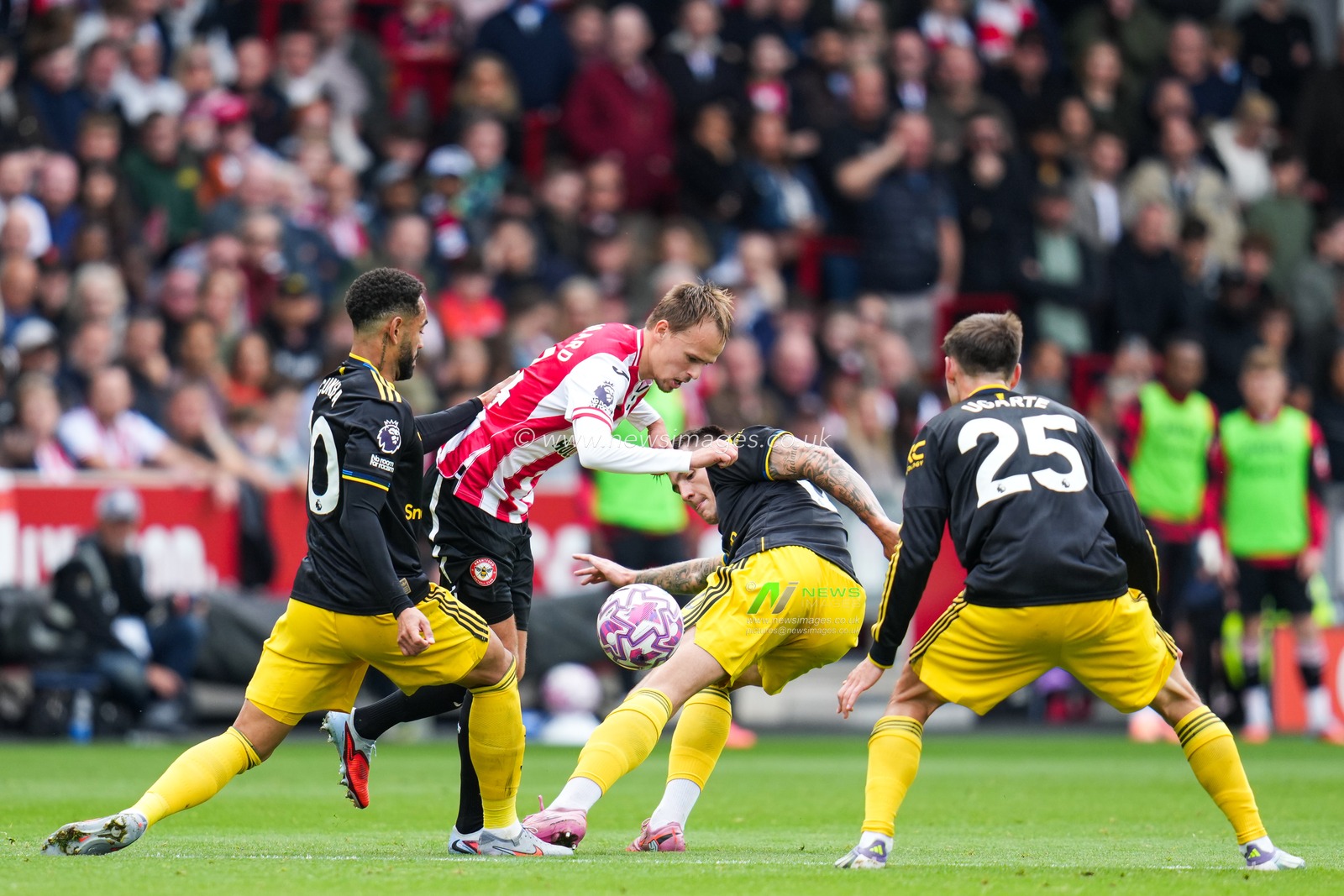 Mikkel Damsgaard of Brentford with the ball under pressure from Manchester United players during the Premier League match Brentford vs Manchester United at The Gtech Community Stadium, London, United Kingdom, 27th September 2025

(Photo by Harvey Murphy/News Images)