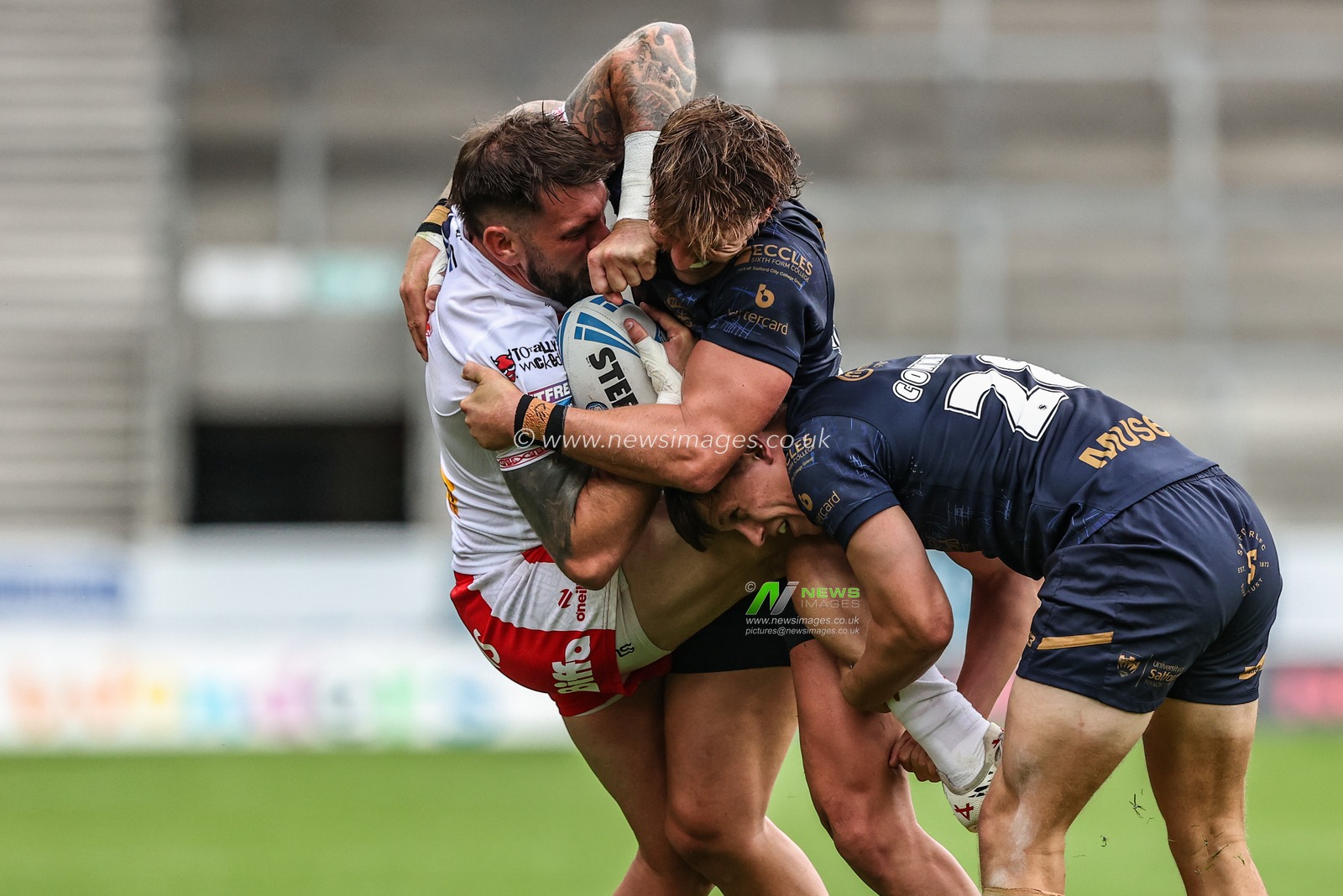 Kyle Feldt of St. Helens is tackled during the Betfred Super League round 16 match St Helens vs Salford Red Devils at Totally Wicked Stadium, St Helens, United Kingdom, 29th June 2025

(Photo by Alfie Cosgrove/News Images)