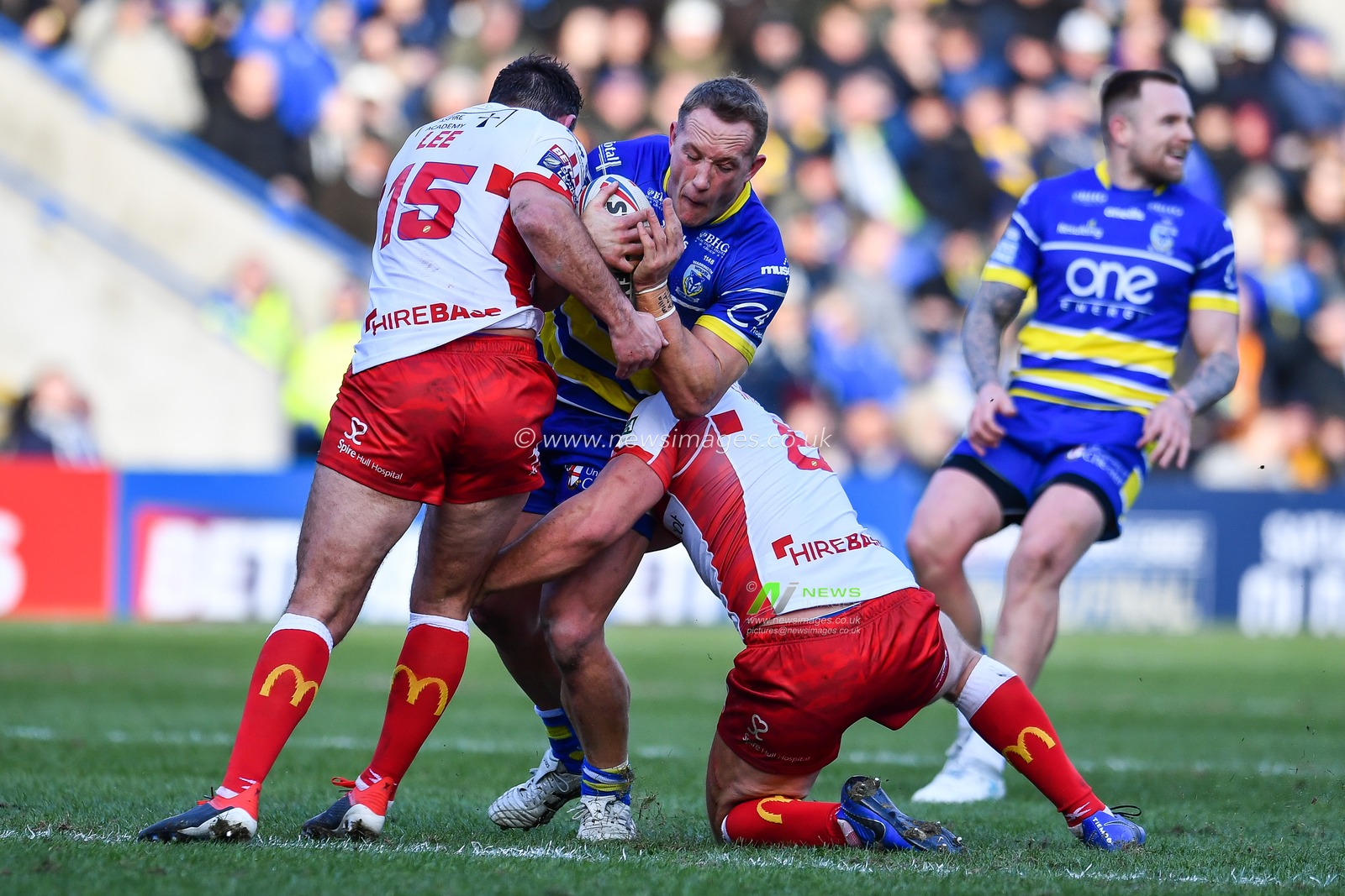 9th February 2019 , Halliwell Jones Stadium, Warrington, England;  Betfred Super League, Round 2, Warrington Wolves vs Hull KR  ; Jason Clark (14) of Warrington is tackled by Robbie Mulhern (8) of Hull KR 

Credit: Craig Thomas/News Images
