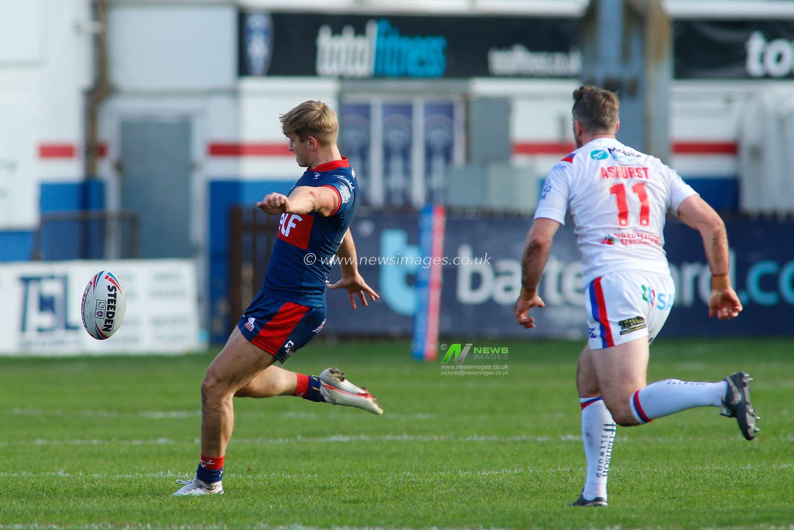 Will Tate (33) of Hull KR kicks the ball downfield against Hull KR.