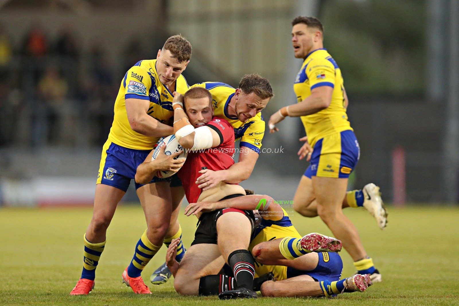 George Williams of Warrington Wolves and Ben Currie of Warrington Wolves tackle Charlie Glover of Salford Red Devils during the Betfred Super League round 17 match Salford Red Devils vs Warrington Wolves at Salford Community Stadium, Eccles, United Kingdom, 4th July 2025(Photo by Sam Eaden/News Images)