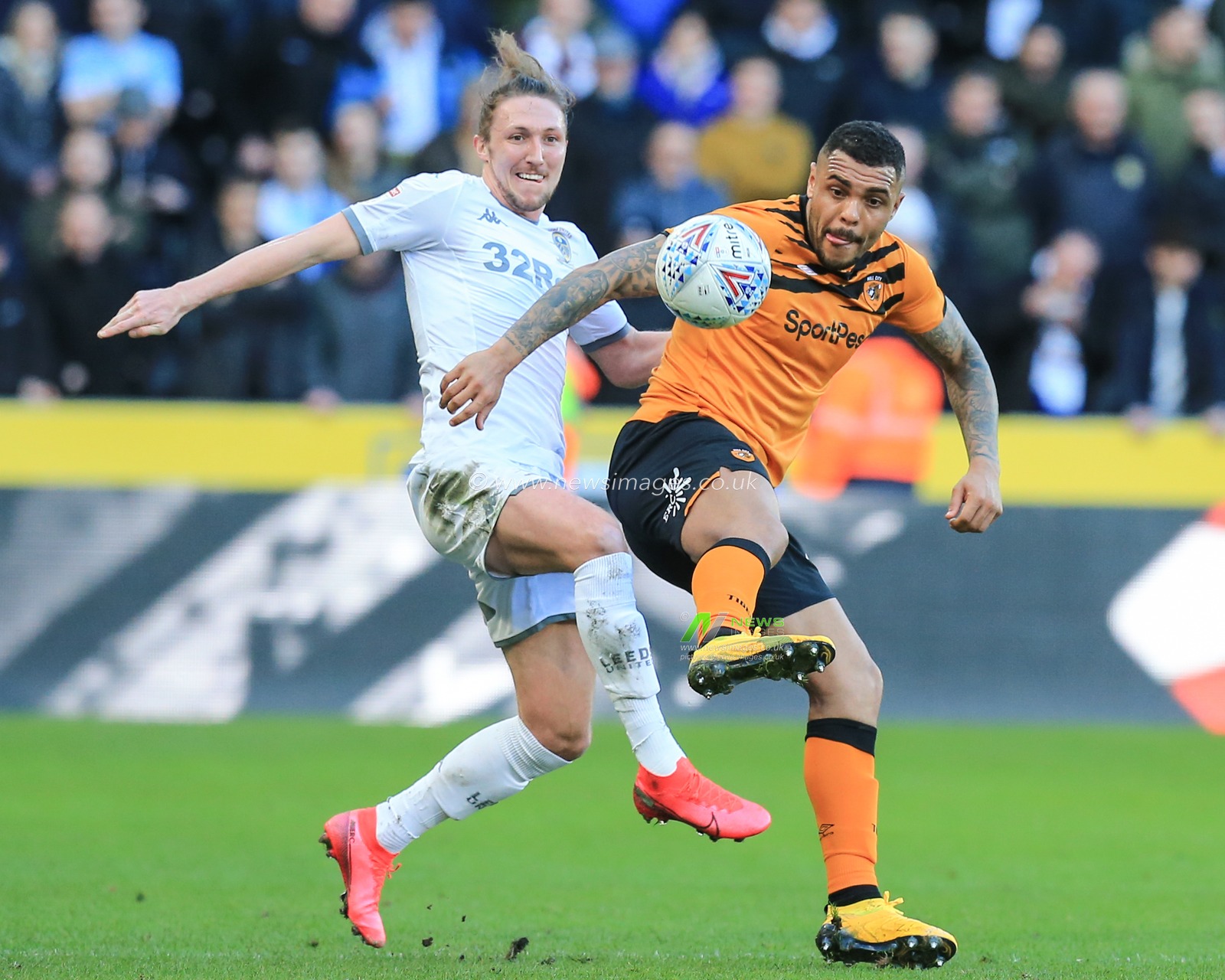 29th February 2020, KCOM Stadium, Hull, England; Sky Bet Championship, Hull City v Leeds United : Josh Magennis (27) of Hull City and Luke Ayling (2) of Leeds United challenge for the ball