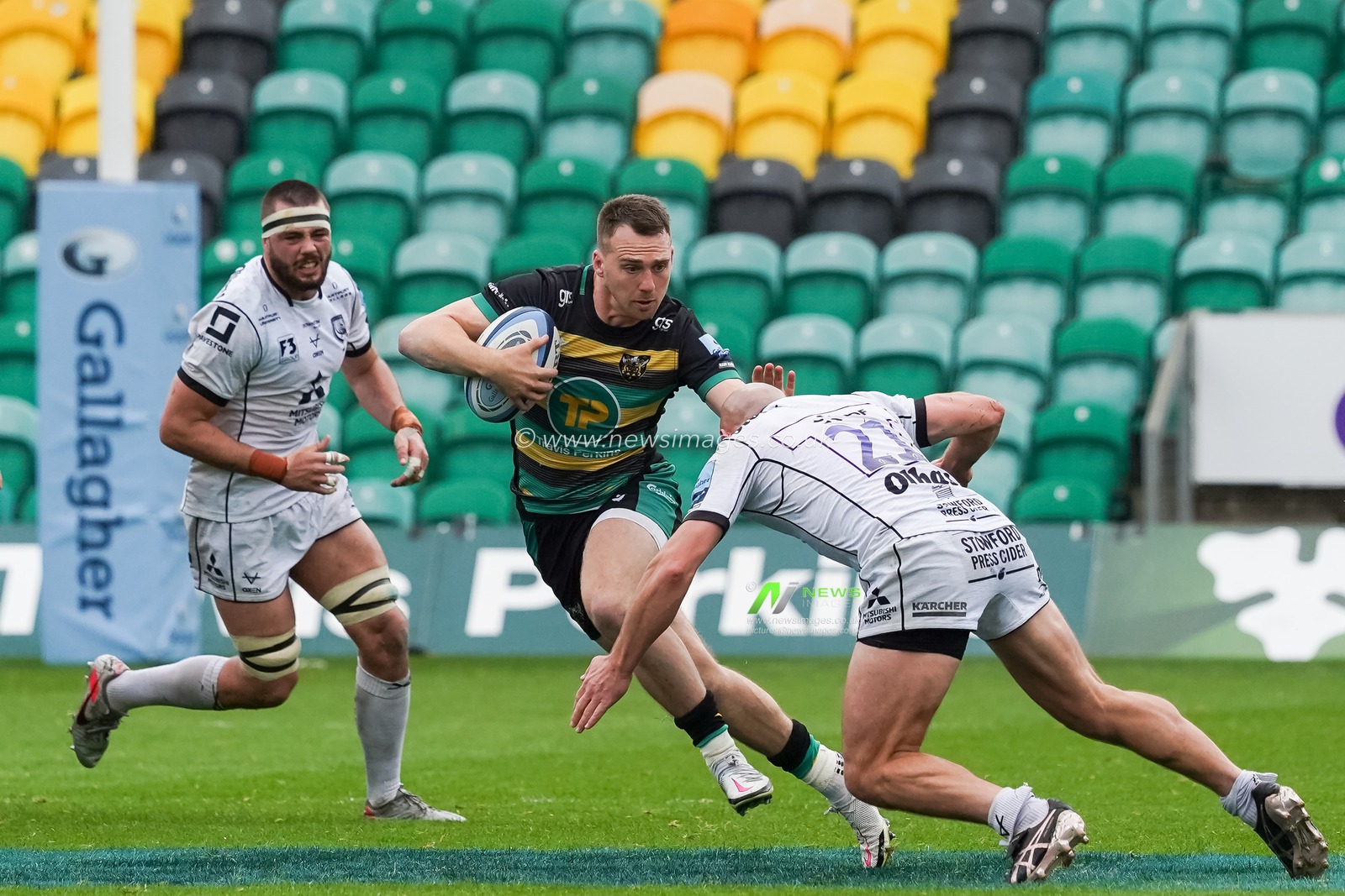 Tom James #9 of Northampton Saints battles with  Will Heinz #21 of Gloucester Rugby