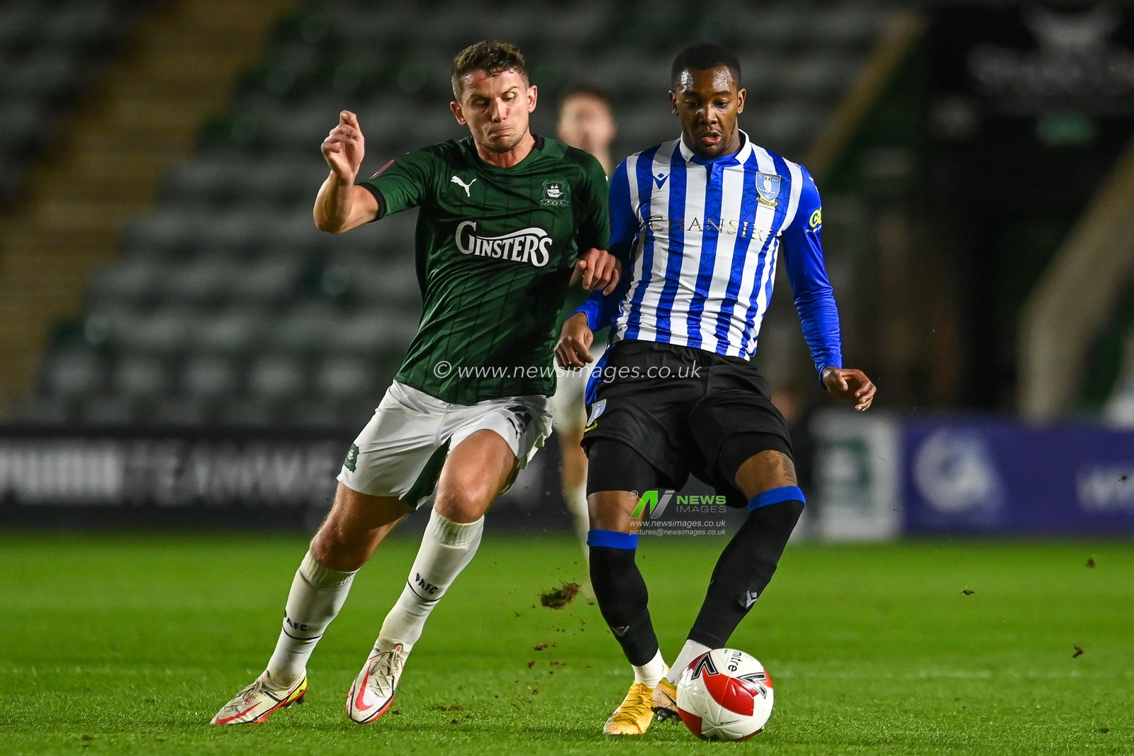 Jaden Brown #3 of Sheffield Wednesday and Jordan Houghton #4 of Plymouth Argyle battles for the ball