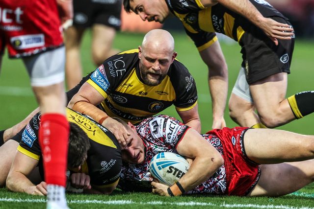 Innes Senior of Leigh Leopards is tackled by Sam Wood of York Knights and Paul McShane of York Knights during the Betfred Super League round 8 match York Knights vs Leigh Leopards at LNER Community Stadium, York, United Kingdom on 17 April 2026

(Photo by Alfie Cosgrove/News Images)