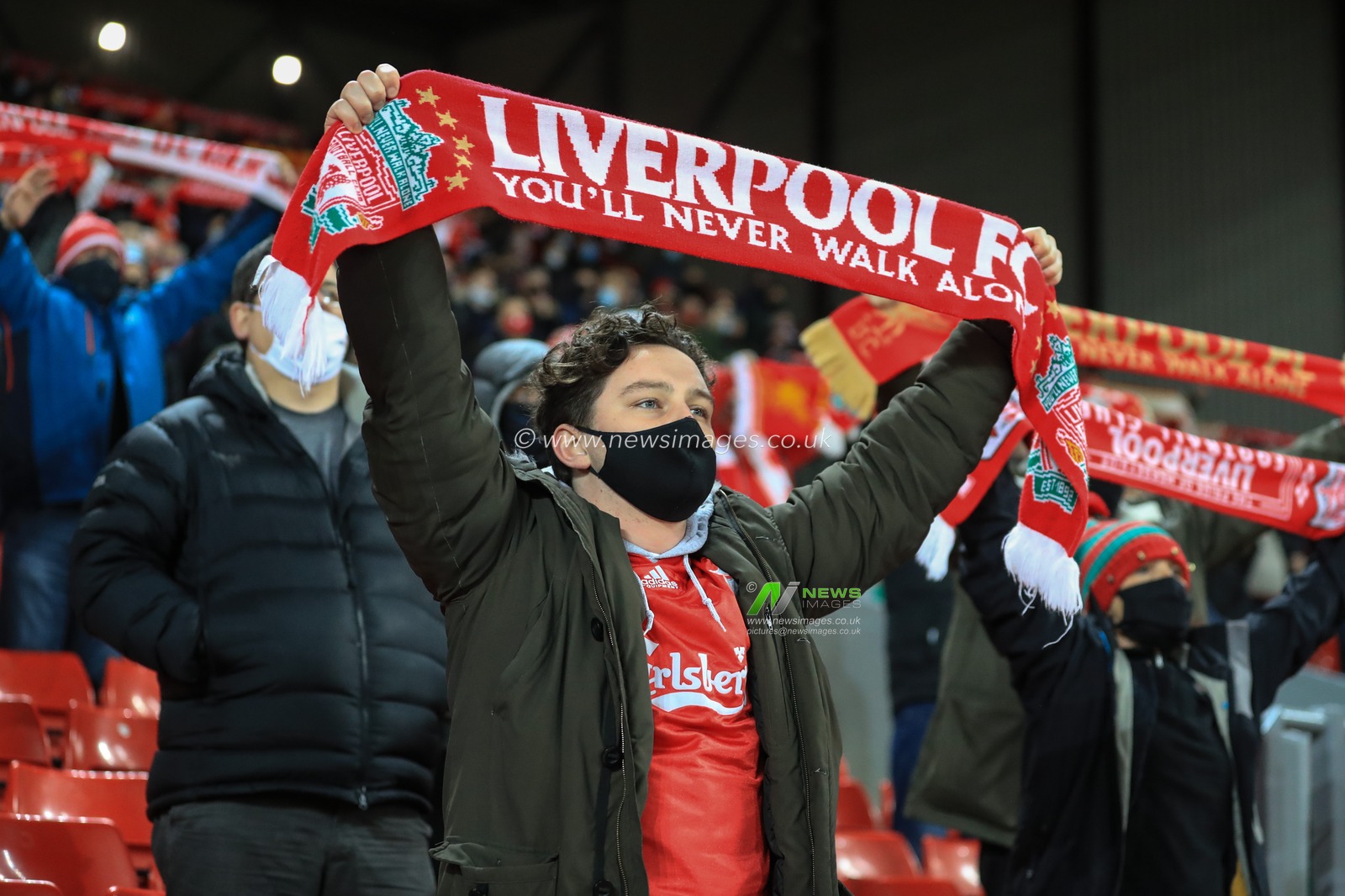 Liverpool fans holds their scarfs up high as they sing â€˜Youâ€™ll Never Walk Aloneâ€™